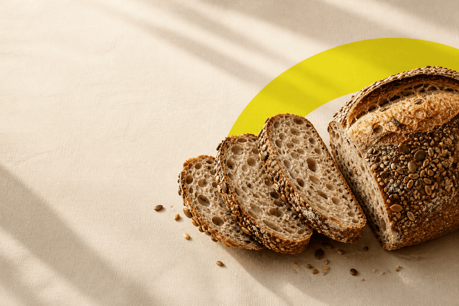 Seeded sourdough bread laid on a cream canvas